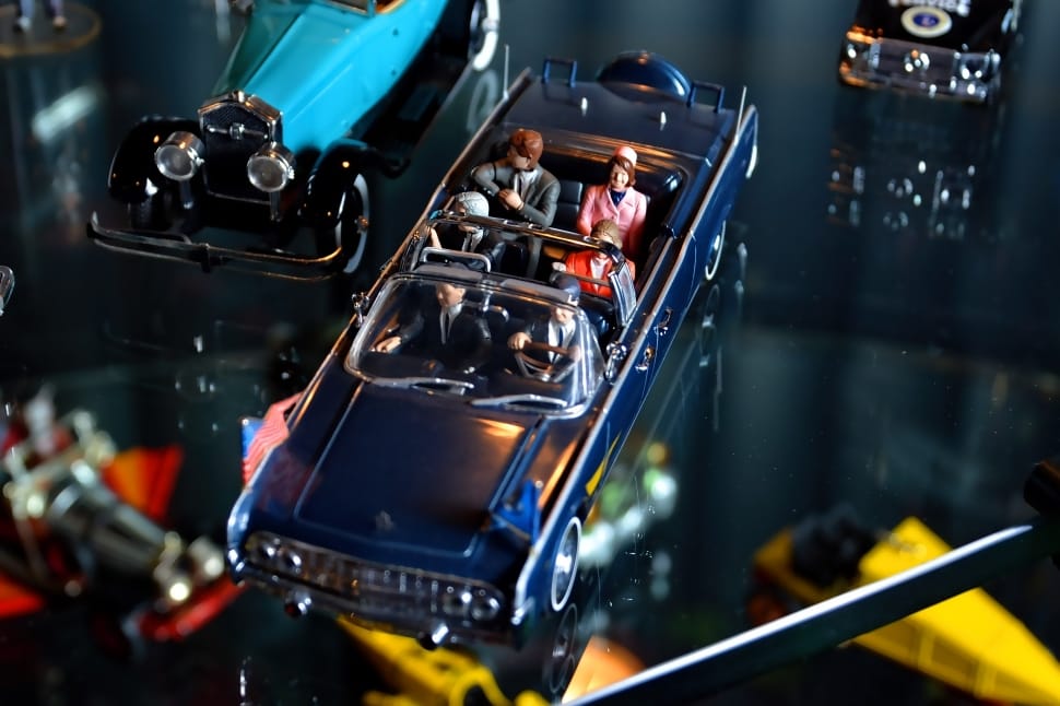 blue convertible sedan with people toy preview