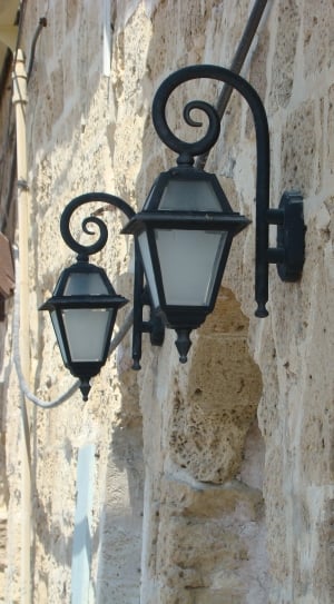 two black sconce lantern on brown wall thumbnail