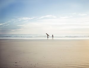 two people on grey sand thumbnail