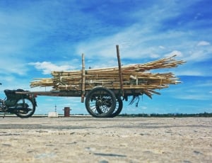 green underbone motorcycle and brown wooden trailer thumbnail