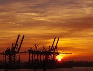 silhouette of tower crane during sun set thumbnail