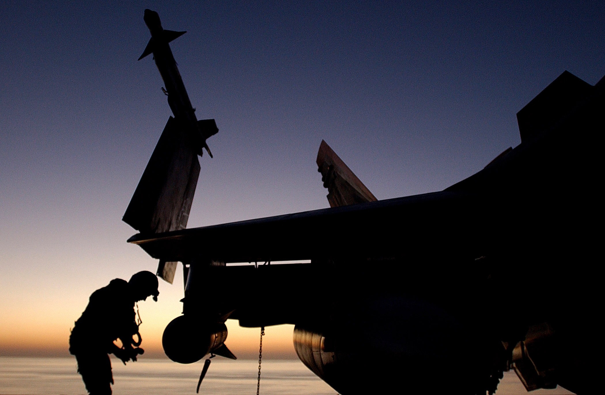 silhouette of fighter plane and pilot