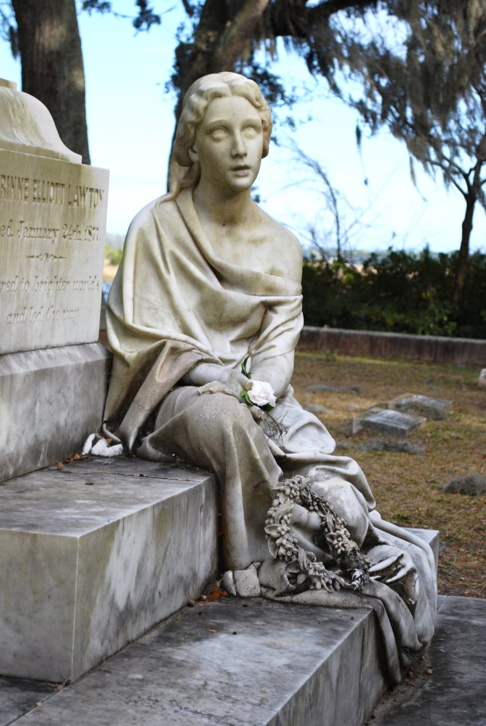 selective focus photography of woman statue sitting on tombstone preview