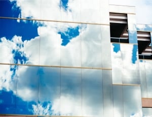 mirrored building blue clouds thumbnail