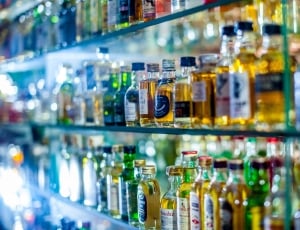 assorted bottles in glass shelves thumbnail