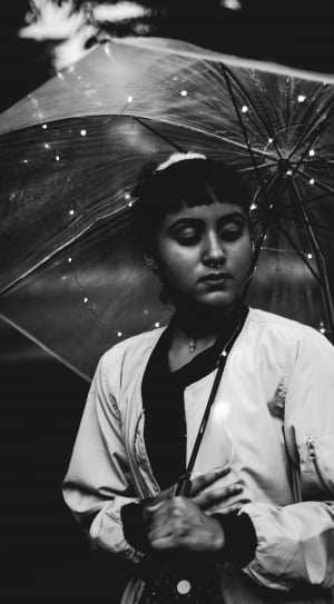 grayscale photograph of a woman under umbrella thumbnail