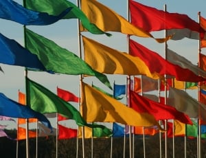 assorted flags under blue skies during daytime thumbnail