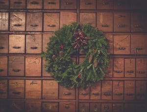 green grass wreath hanged on wooden drawers thumbnail