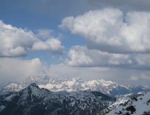 high mountains under the clouds during day time thumbnail