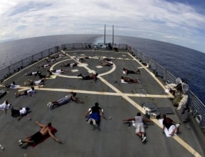 people on the ship doing activity high angle photography thumbnail