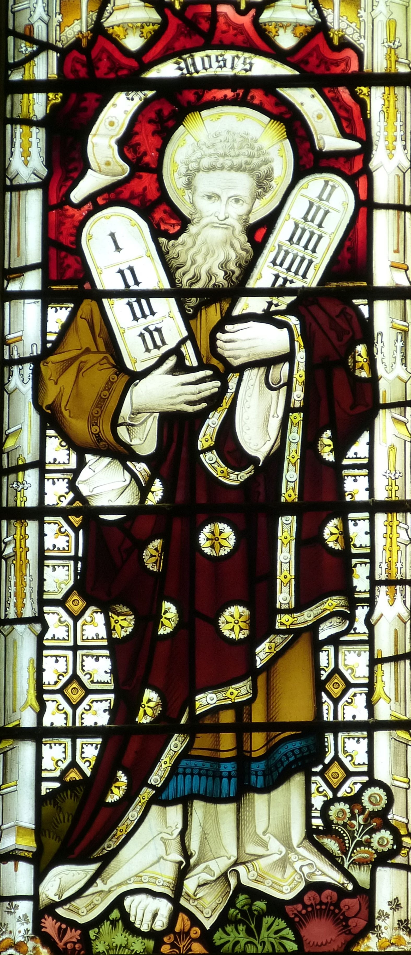 man holding blocks maroon red and white tainted glass