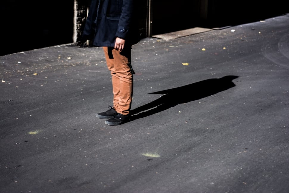 close up photo of person with brown pants and black shoes preview