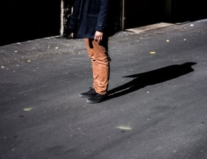 close up photo of person with brown pants and black shoes thumbnail