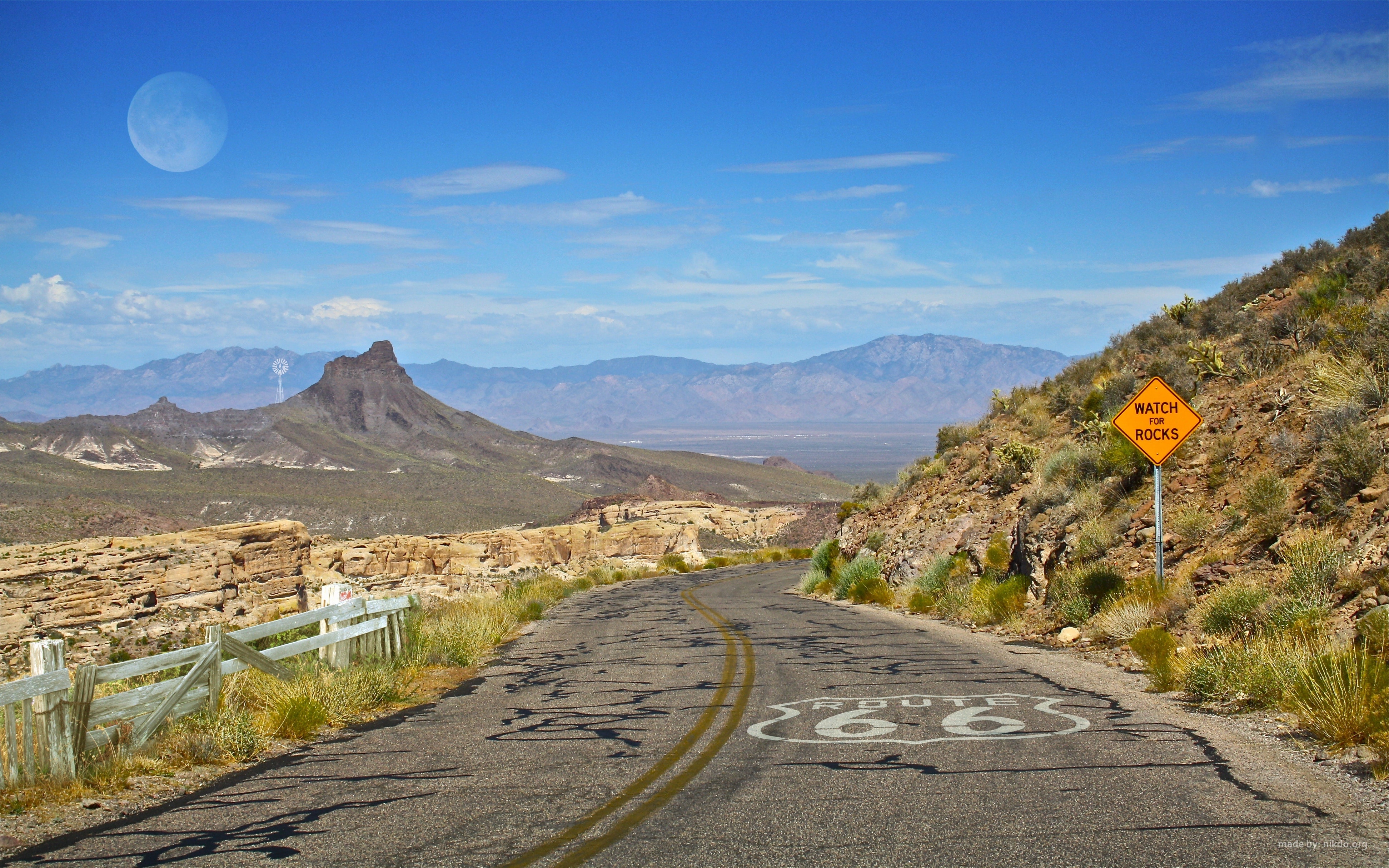 Route 66 road in a distance of a moon view at daytime