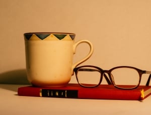 brown frame eyeglasses book and mug thumbnail