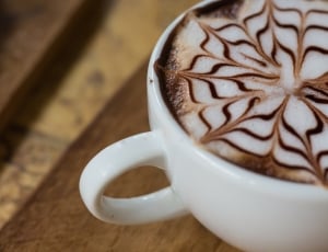 latte art on brown ceramic mug thumbnail
