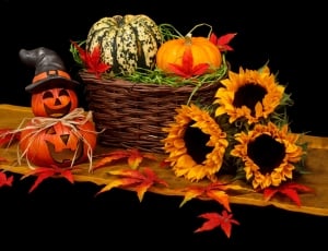 pumpkin,jack o lantern and sunflower ornaments with brown wicker basket thumbnail