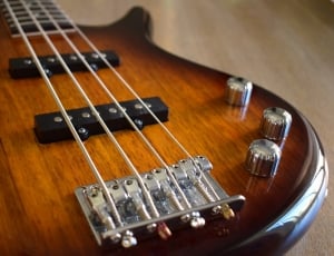 brown wooden electric bass guitar thumbnail