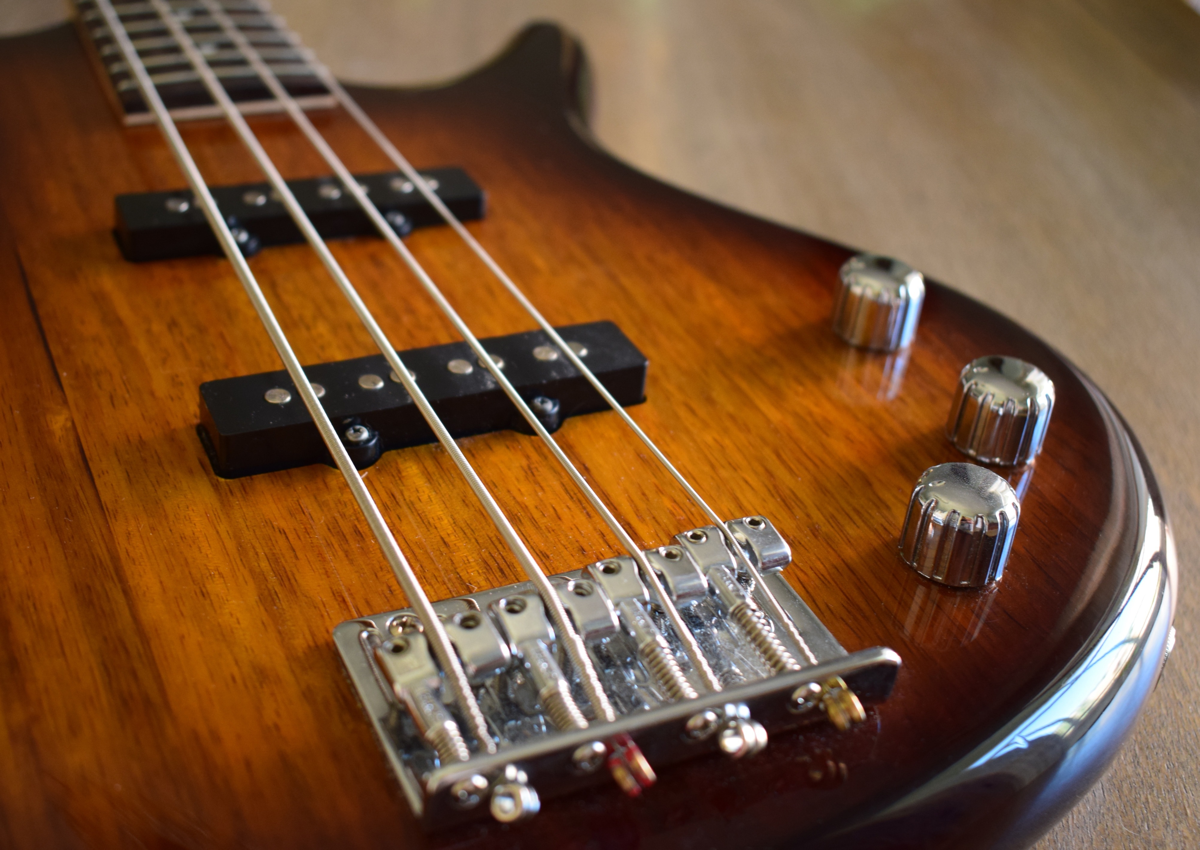 brown wooden electric bass guitar