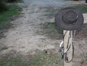 black cowboy hat on brown wood thumbnail