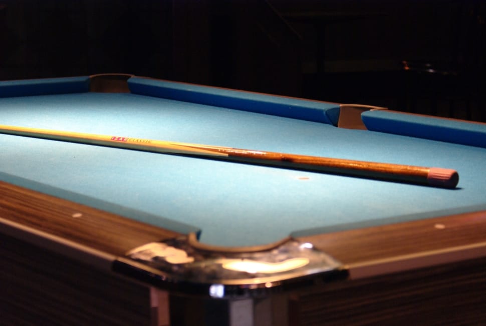 brown and blue billiard table and cue stick preview