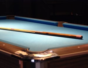 brown and blue billiard table and cue stick thumbnail