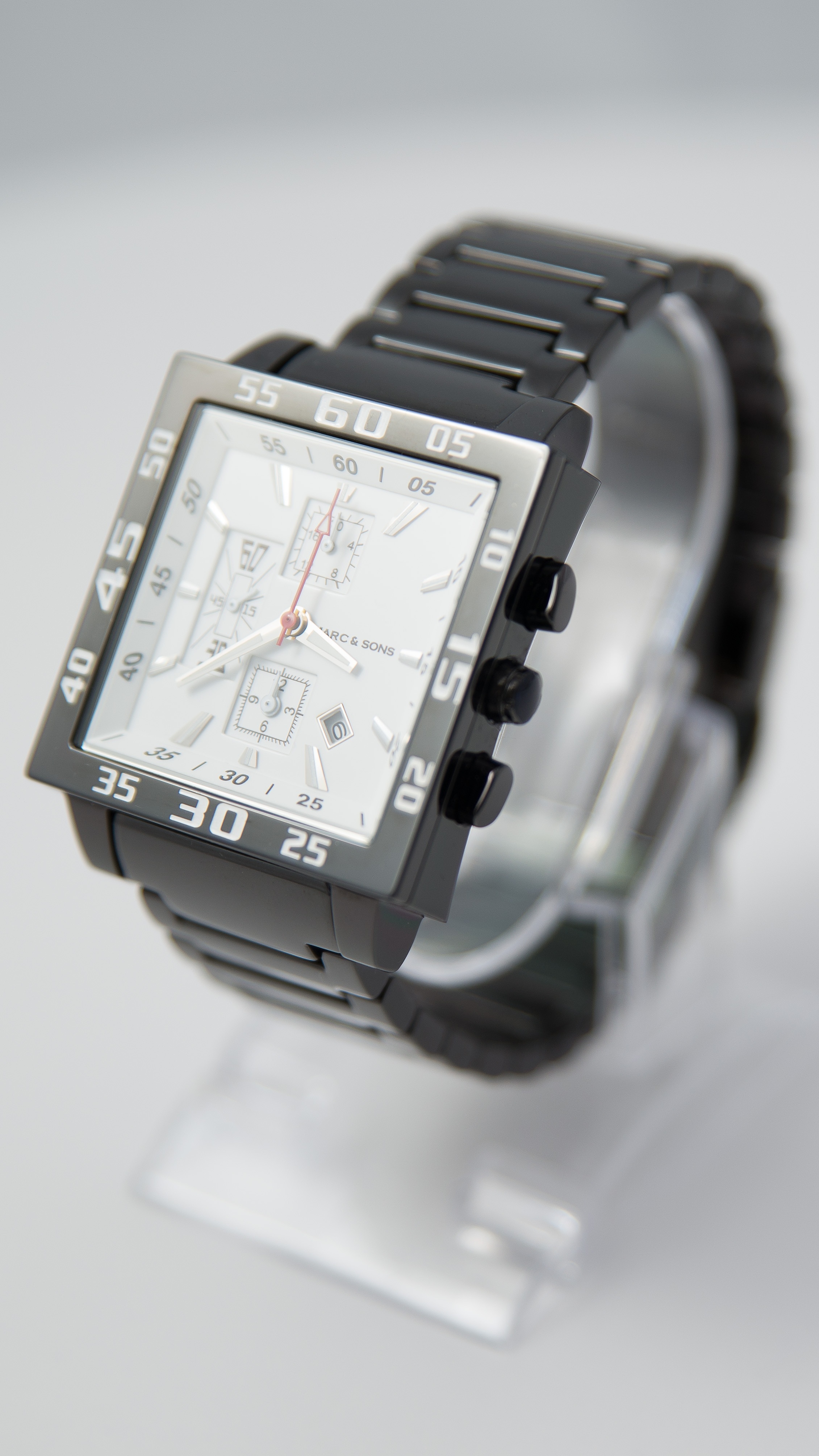 rectangular black chronograph watch with chain strap