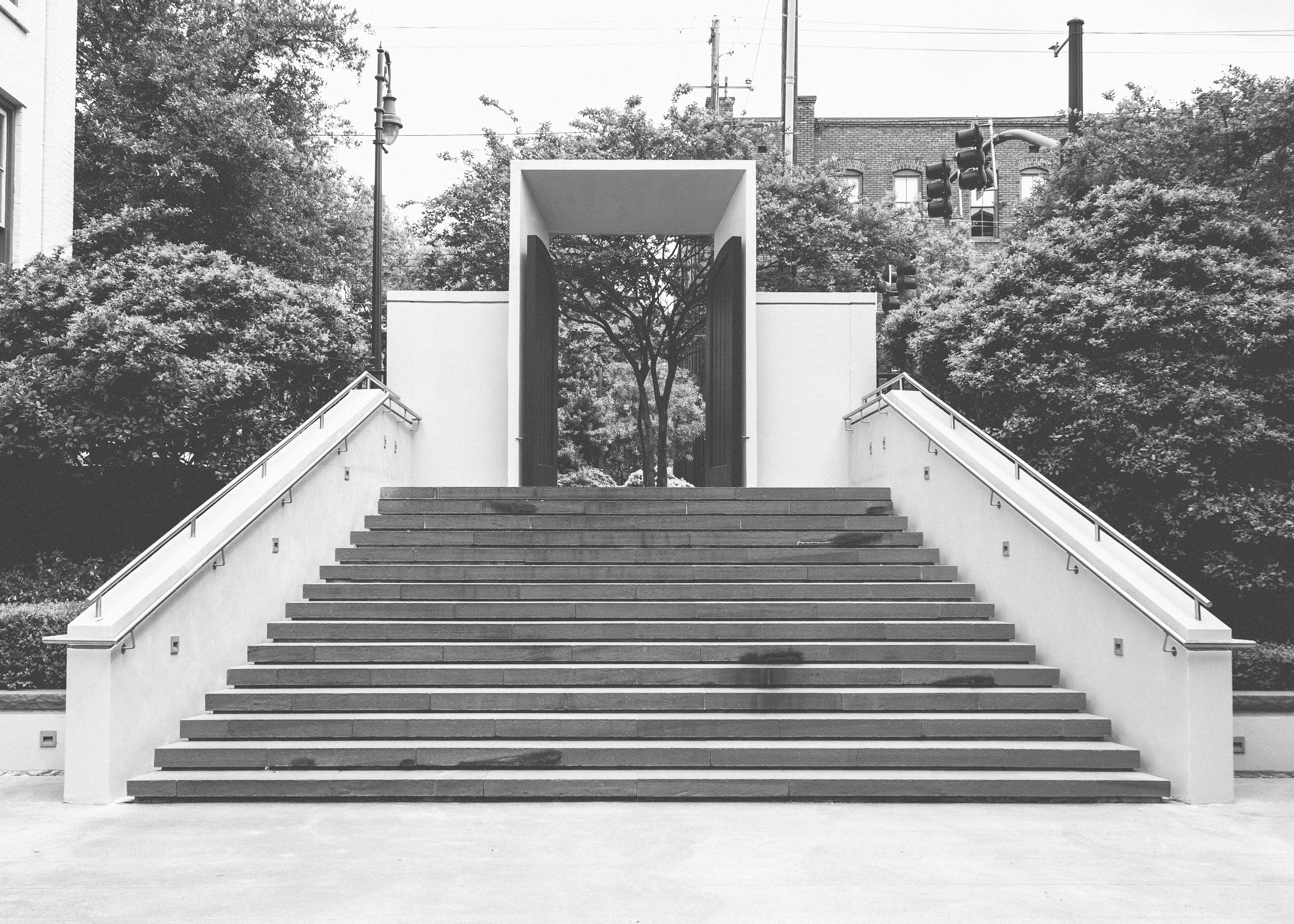 grayscale photo of outdoor concrete staircase
