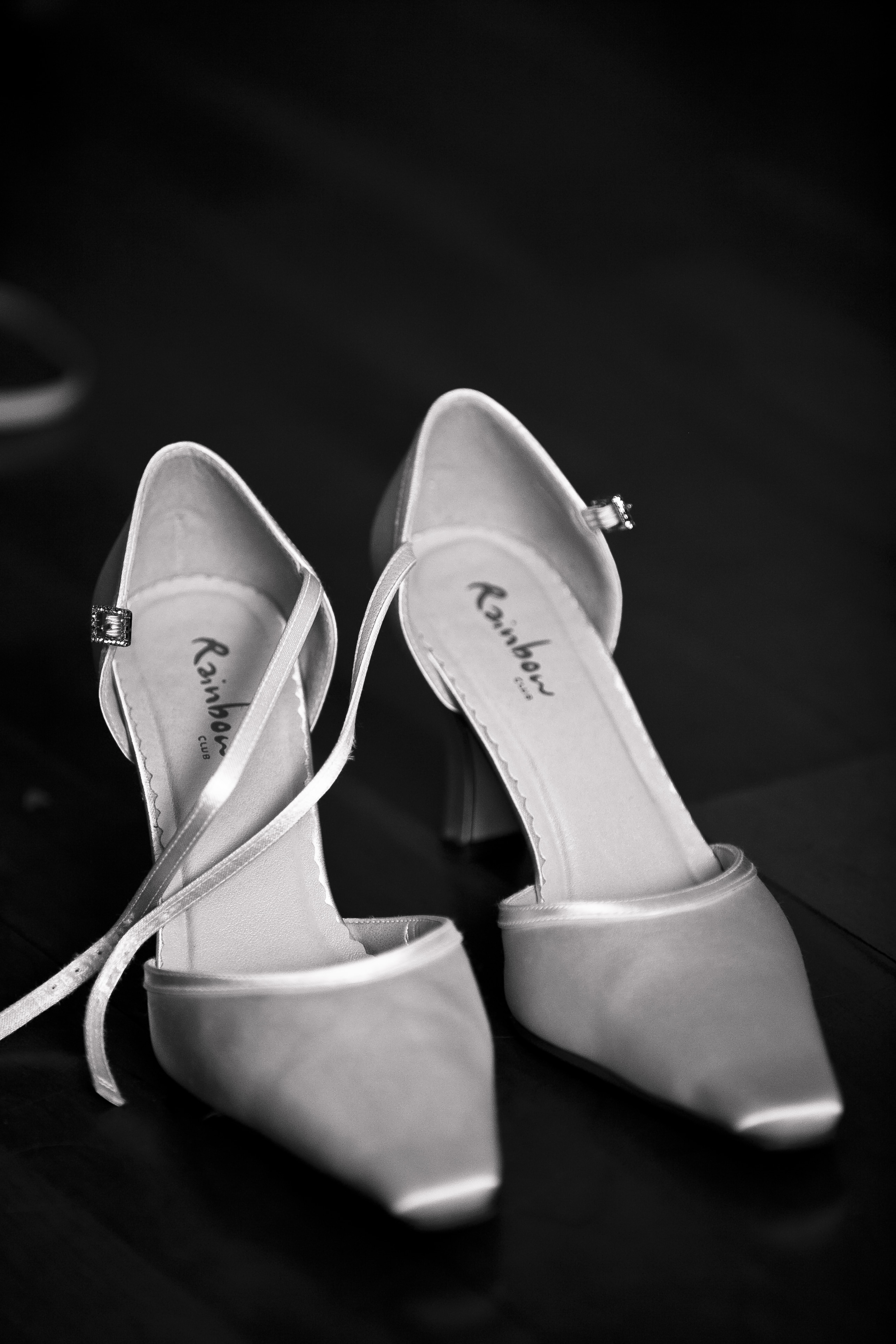 pair of white pointed toe ankle strap pumps