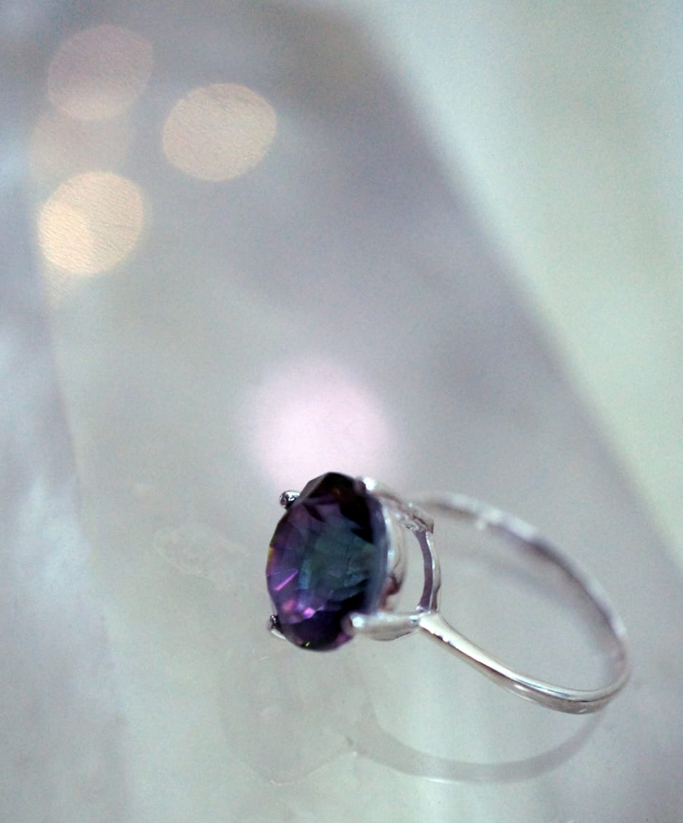 silver and blue gemstone ring on white surface preview