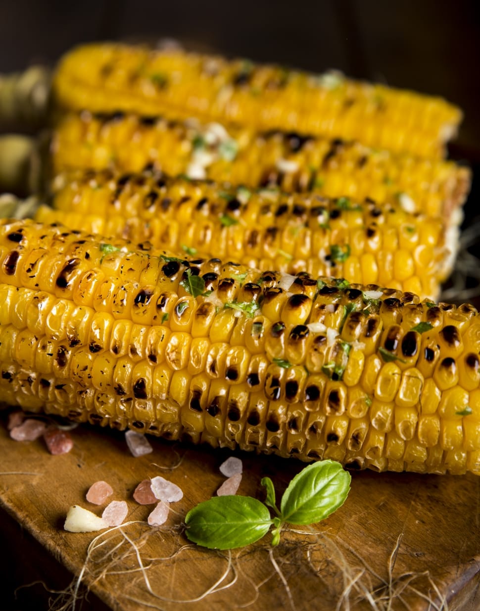grilled corn on the cob with basil on top preview