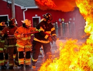 four fireman holding fire-hose near fire thumbnail