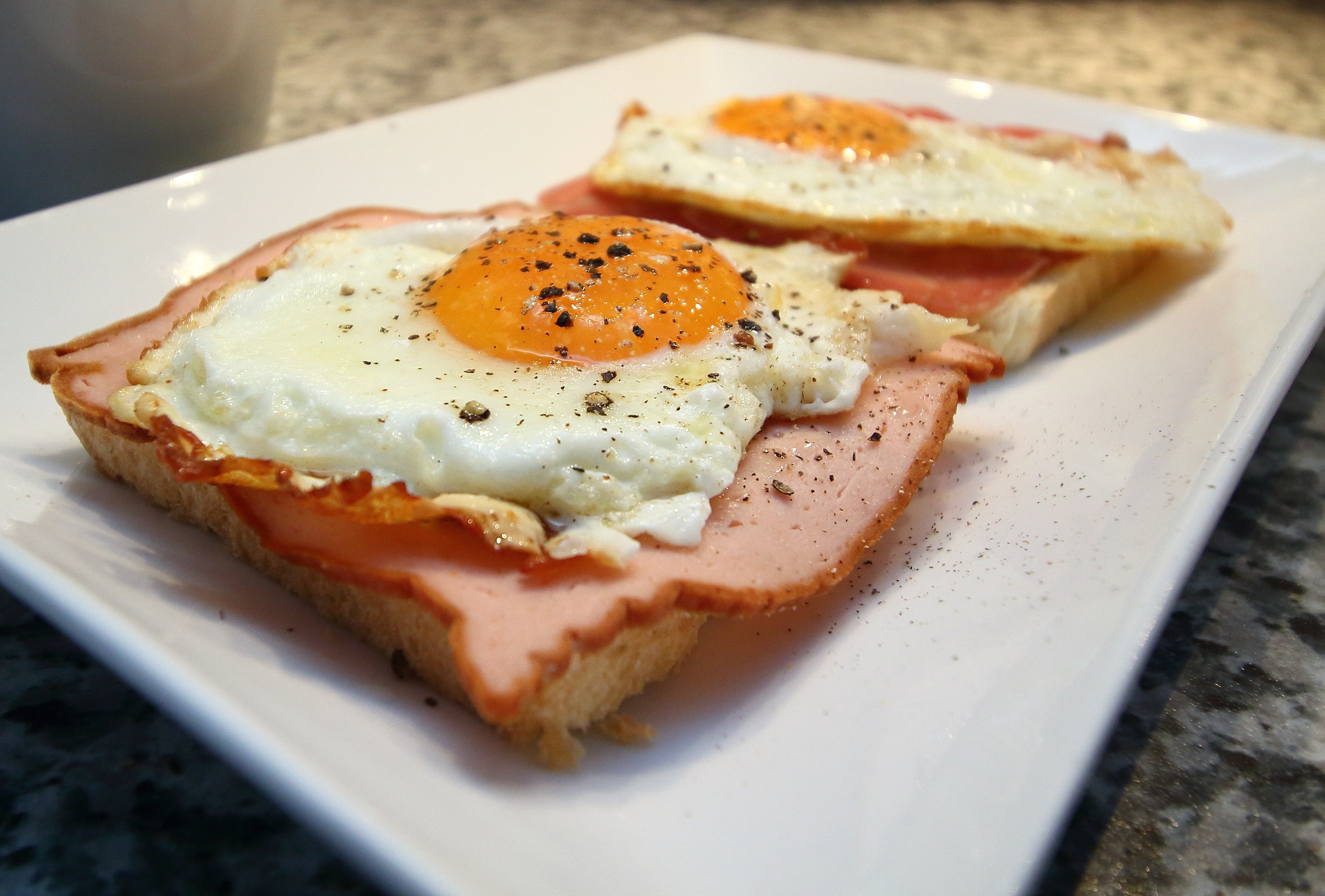 bread with ham and sunny side up egg