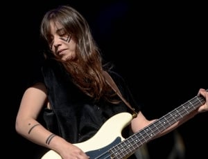 woman playing bass guitar thumbnail