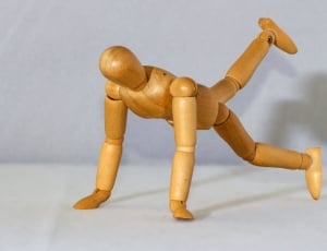 brown wooden human figurine thumbnail