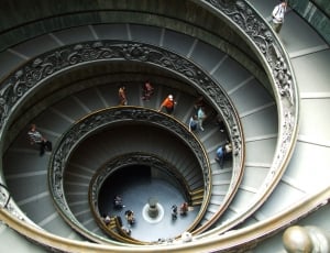 building interior spiral staircase with people walking thumbnail