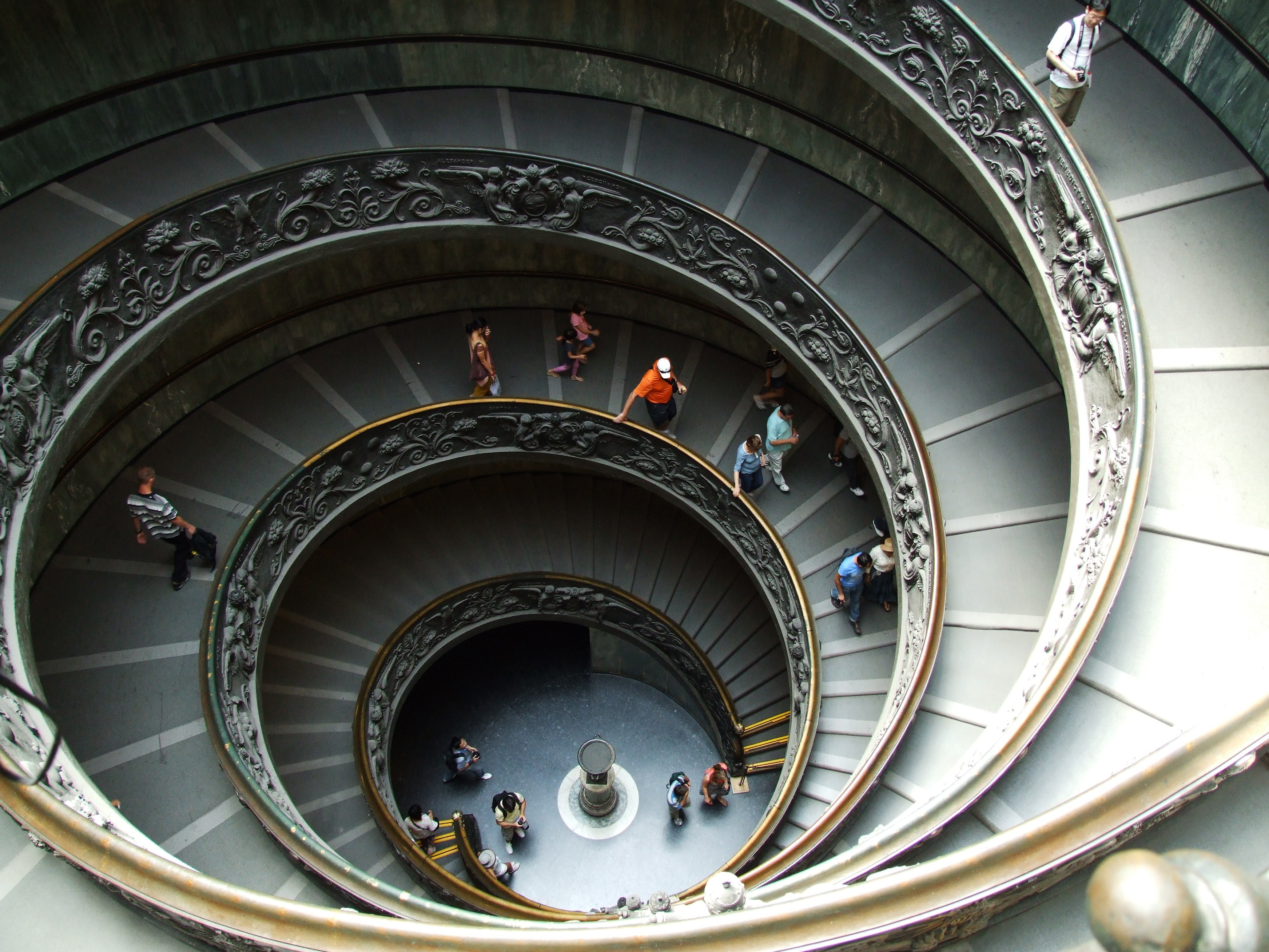 building interior spiral staircase with people walking