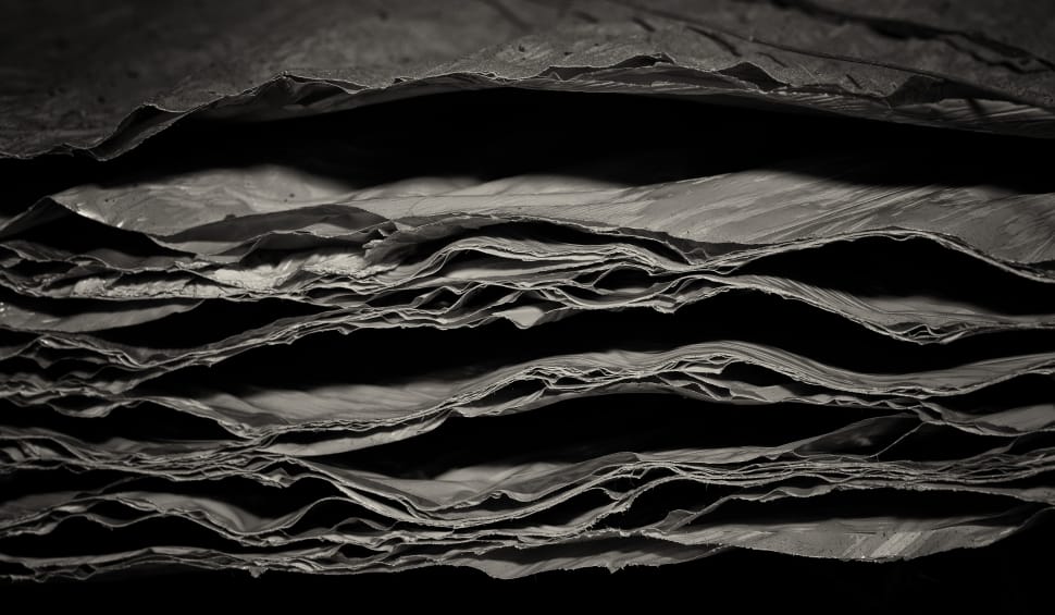 greyscale photo of pile of sheets preview