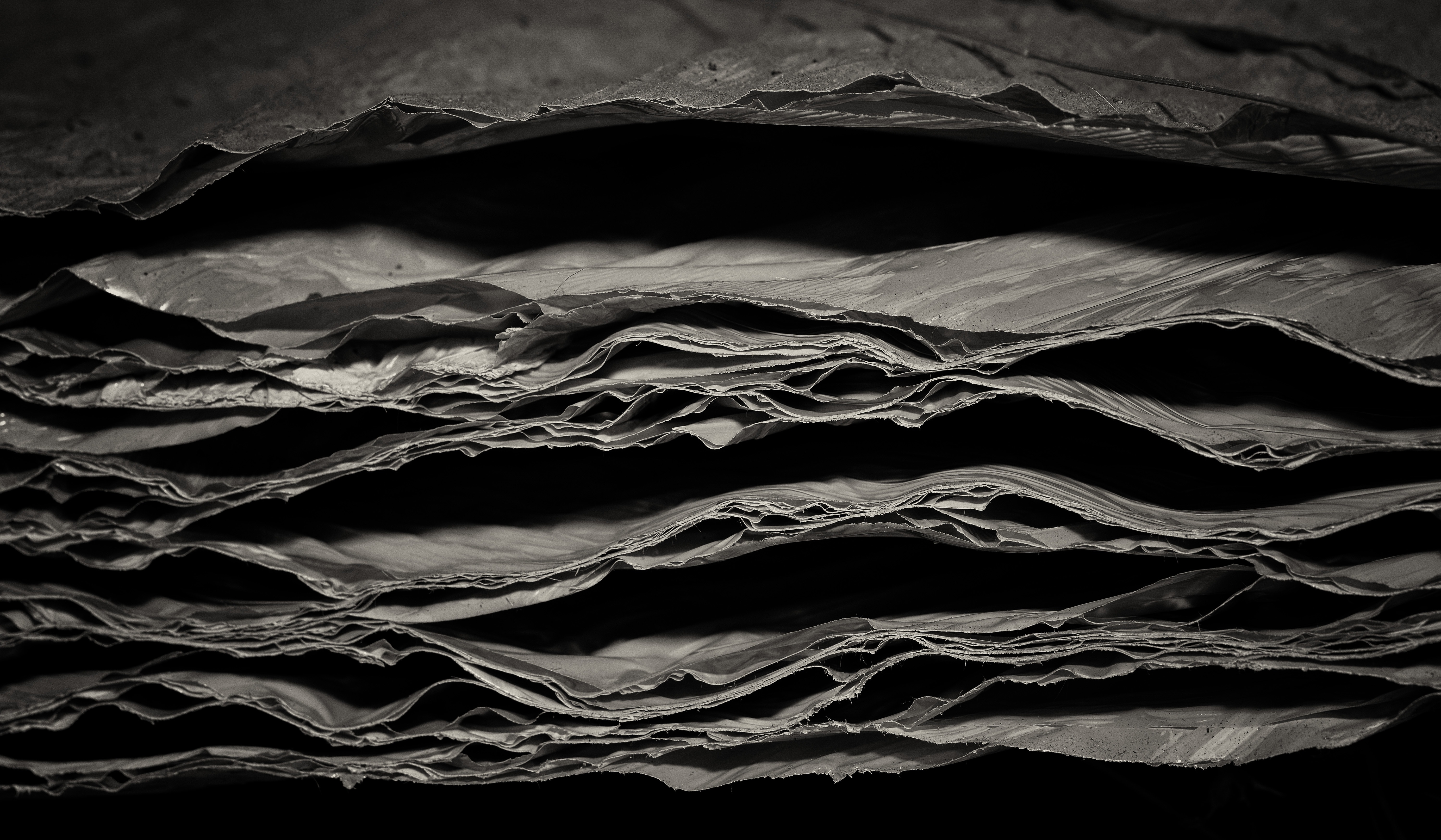 greyscale photo of pile of sheets