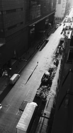 grayscale aerial photo road filled with trucks and vehicles thumbnail