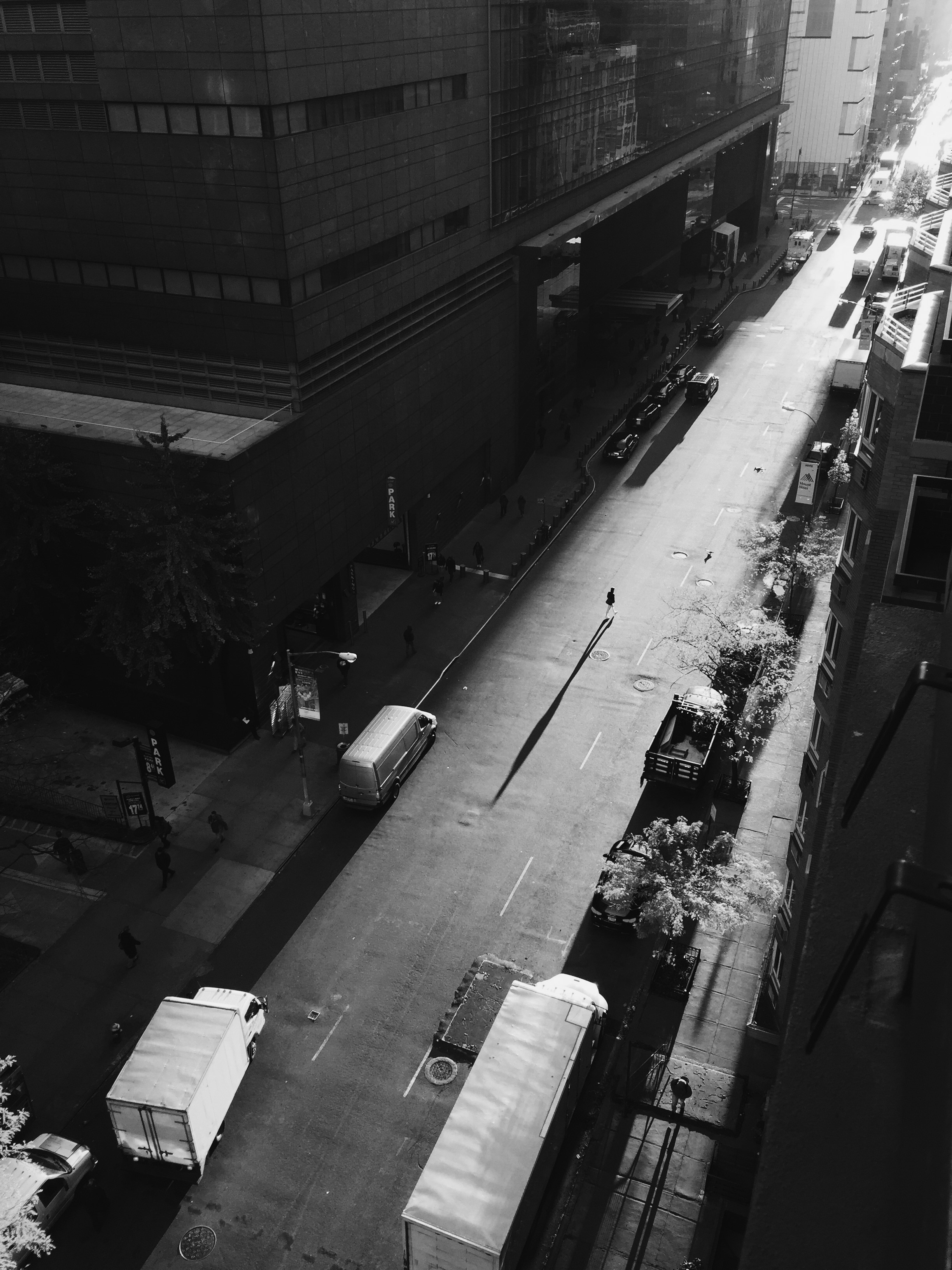 grayscale aerial photo road filled with trucks and vehicles