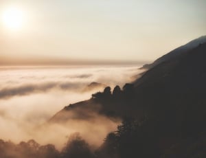 mountain covered with fog during sunset thumbnail