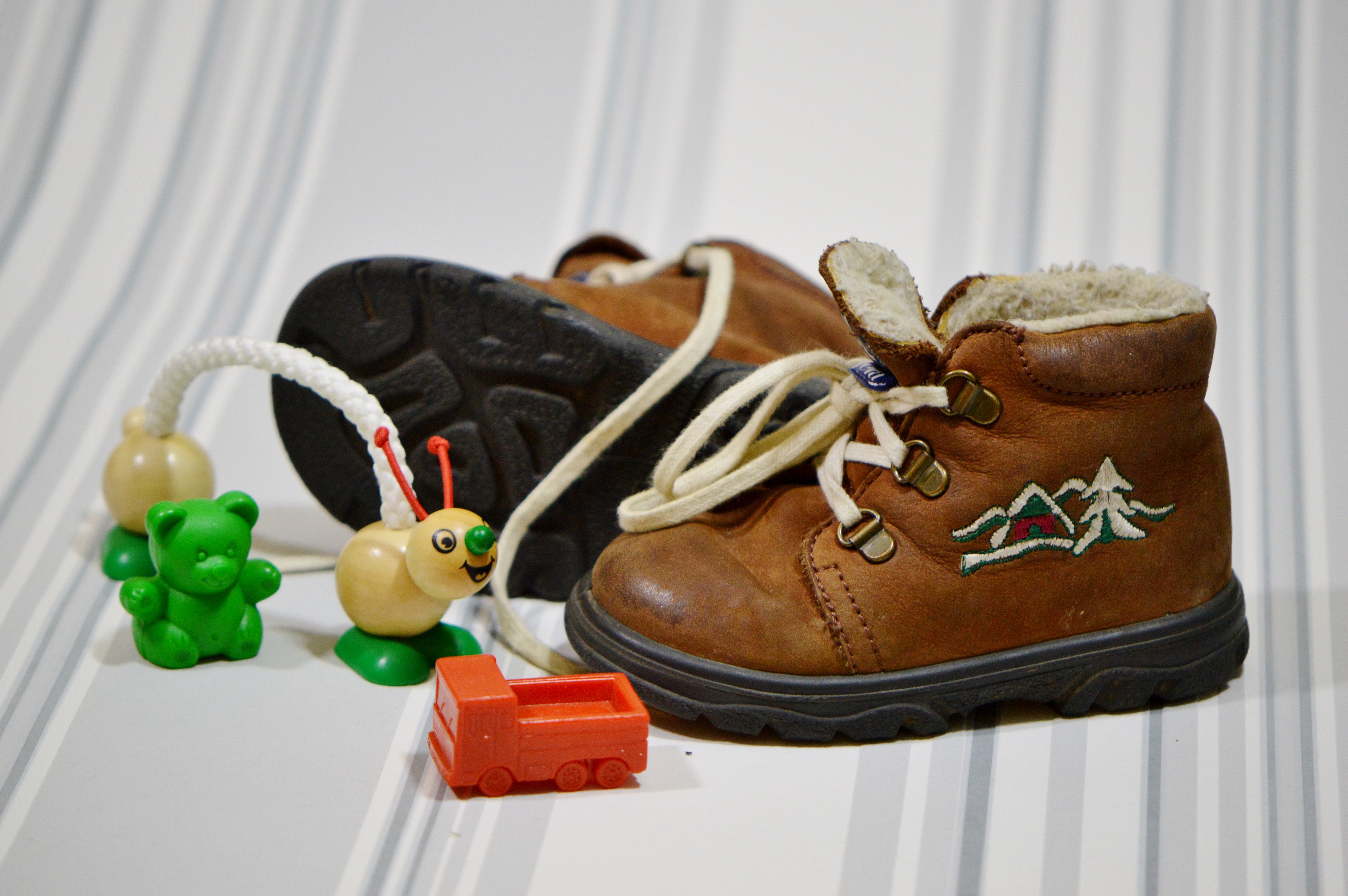 pair of black-and-brown leather boots and plastic toys