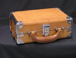 brown leather suitcase on black textile thumbnail