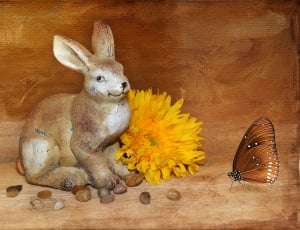 brown ceramic hare figurine beside sunflower and butterfly figurine thumbnail