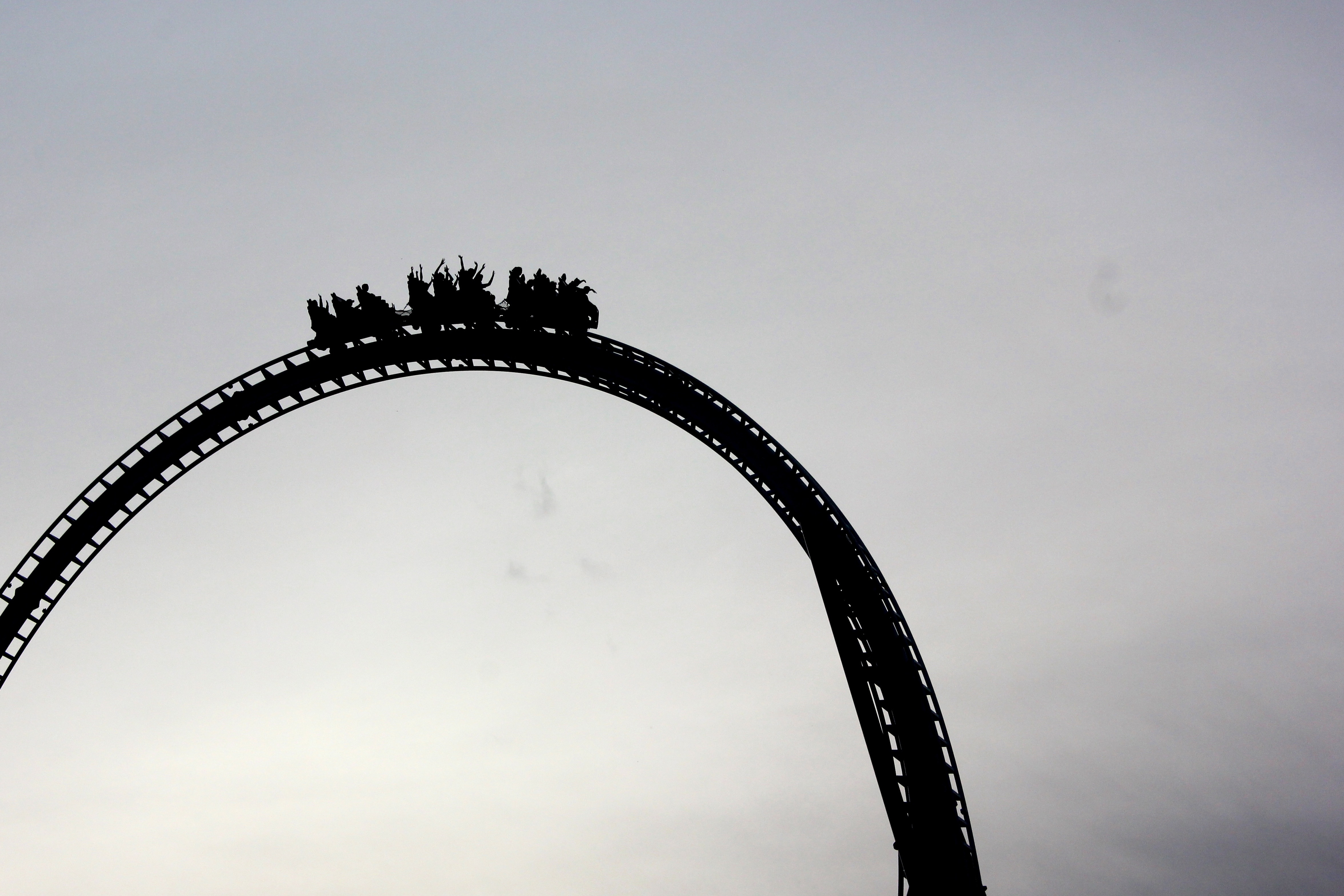 silhouette of people on roller coaster
