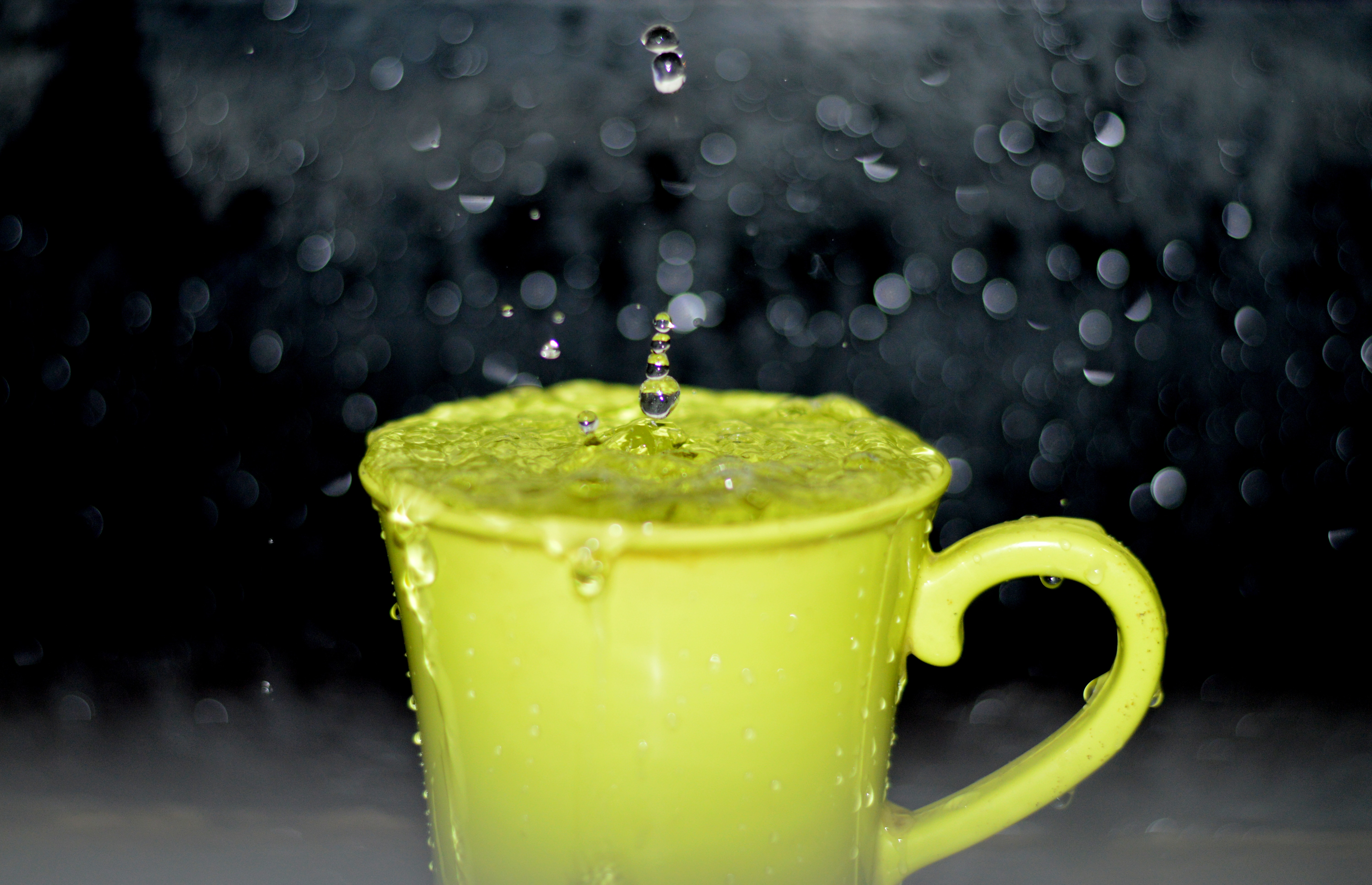 yellow ceramic mug with flowing water timelapse photography