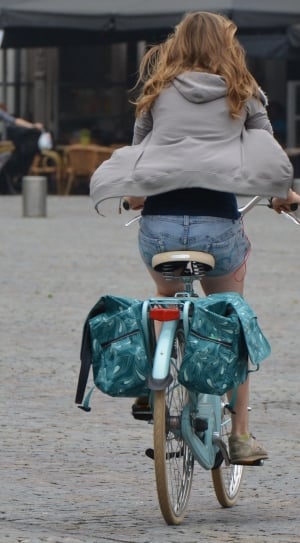 woman riding bicycle during daytime thumbnail