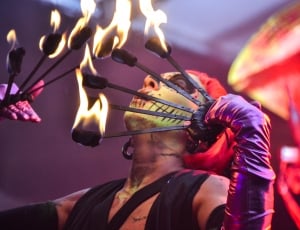 woman with sugar skull face painting doing firedance shallow depth photography thumbnail