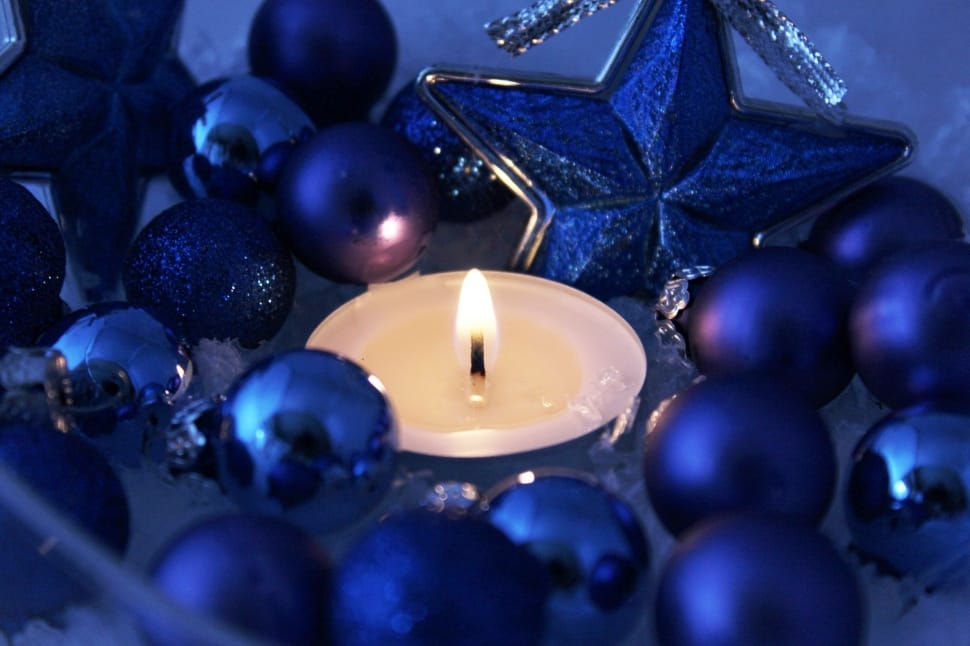 white candle beside blue beads preview
